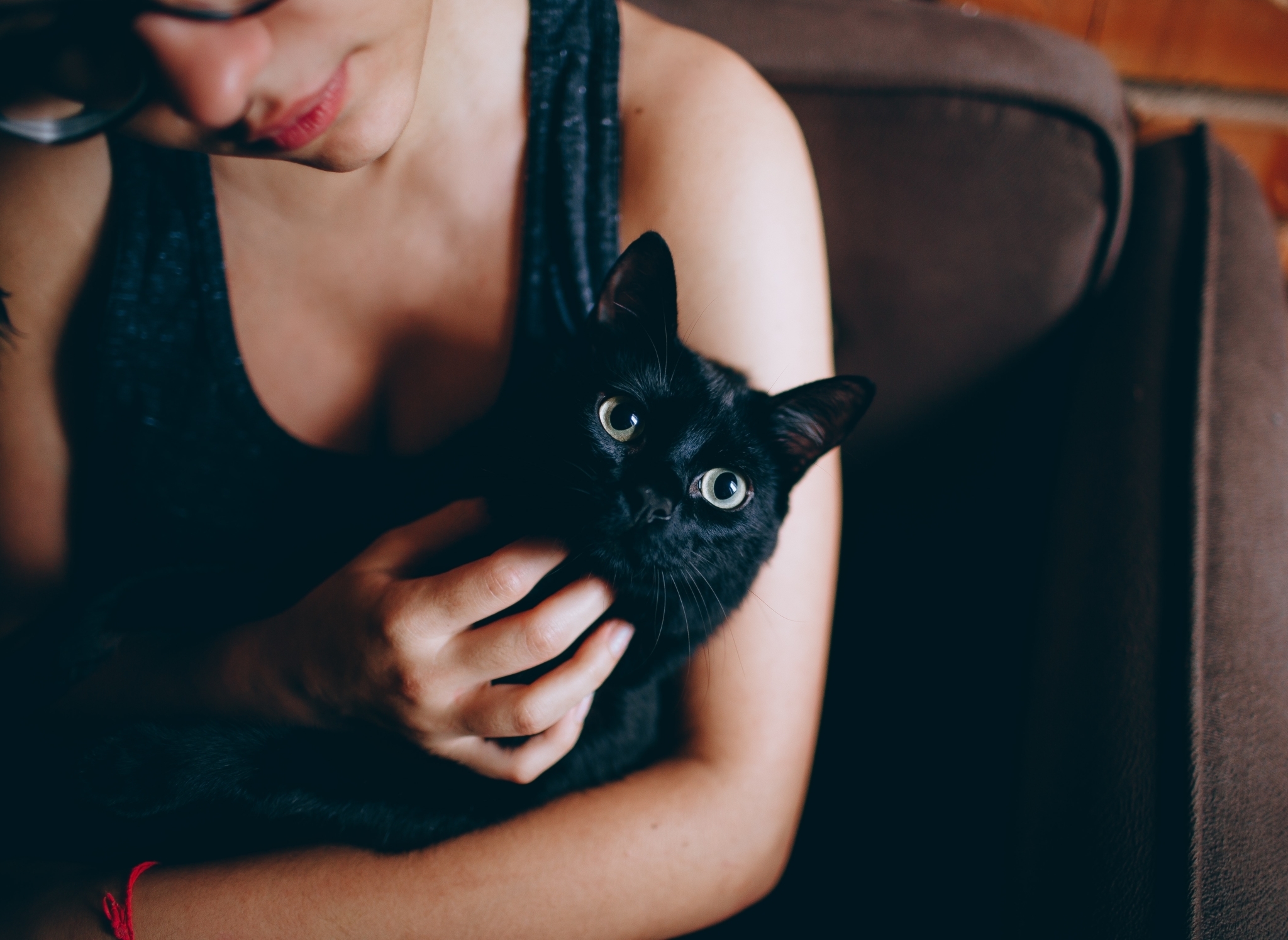 woman holding black cat